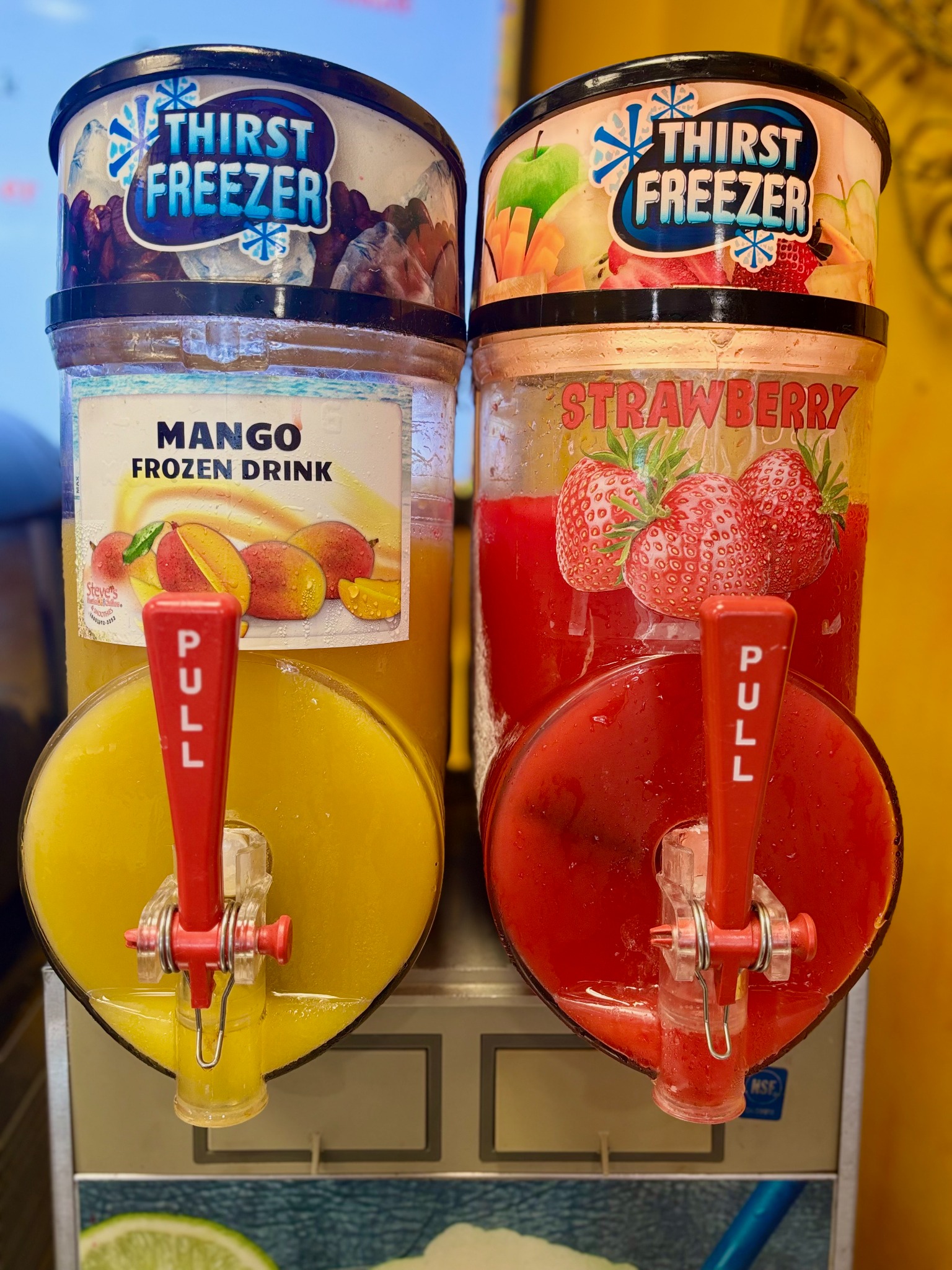 Mango and strawberry slushy dispensers